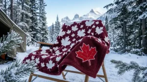 Close-up of a premium fleece blanket featuring a white and red Canadian maple leaf pattern, designed for durability in extreme cold weather.