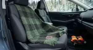 A durable, reusable wool emergency car blanket draped across a vehicle seat ready for emergencies.