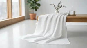 A wrinkle-free white photography backdrop blanket draped smoothly across a professional portrait studio floor.